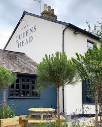 'The Queen's Head' featuring a garden and greenery in the foreground.